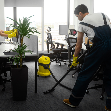 Cleaning team vacuuming an office floor