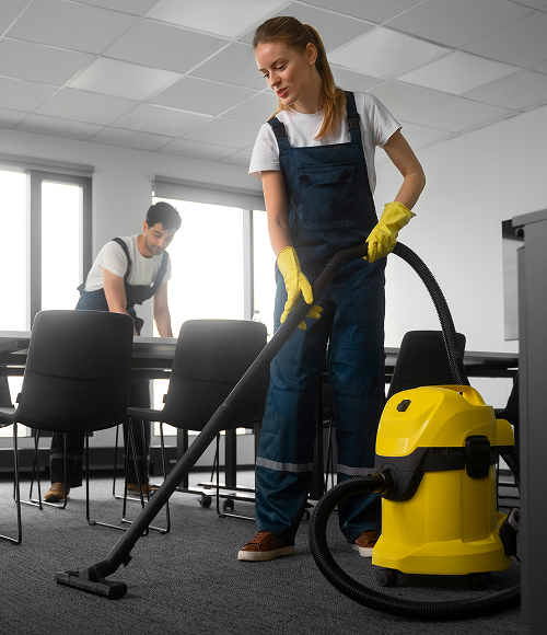 Cleaner operating a yellow floor scrubbing machine